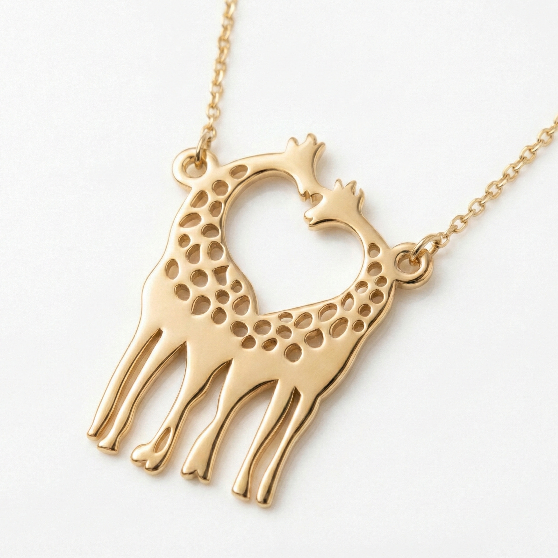 Gold giraffe-shaped pendant on a chain against a white background