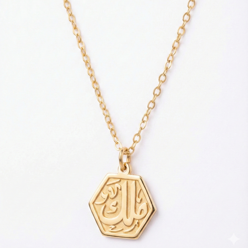 Gold necklace with a hexagonal pendant on a white background
