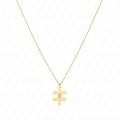 Gold necklace with a puzzle piece pendant on a white background